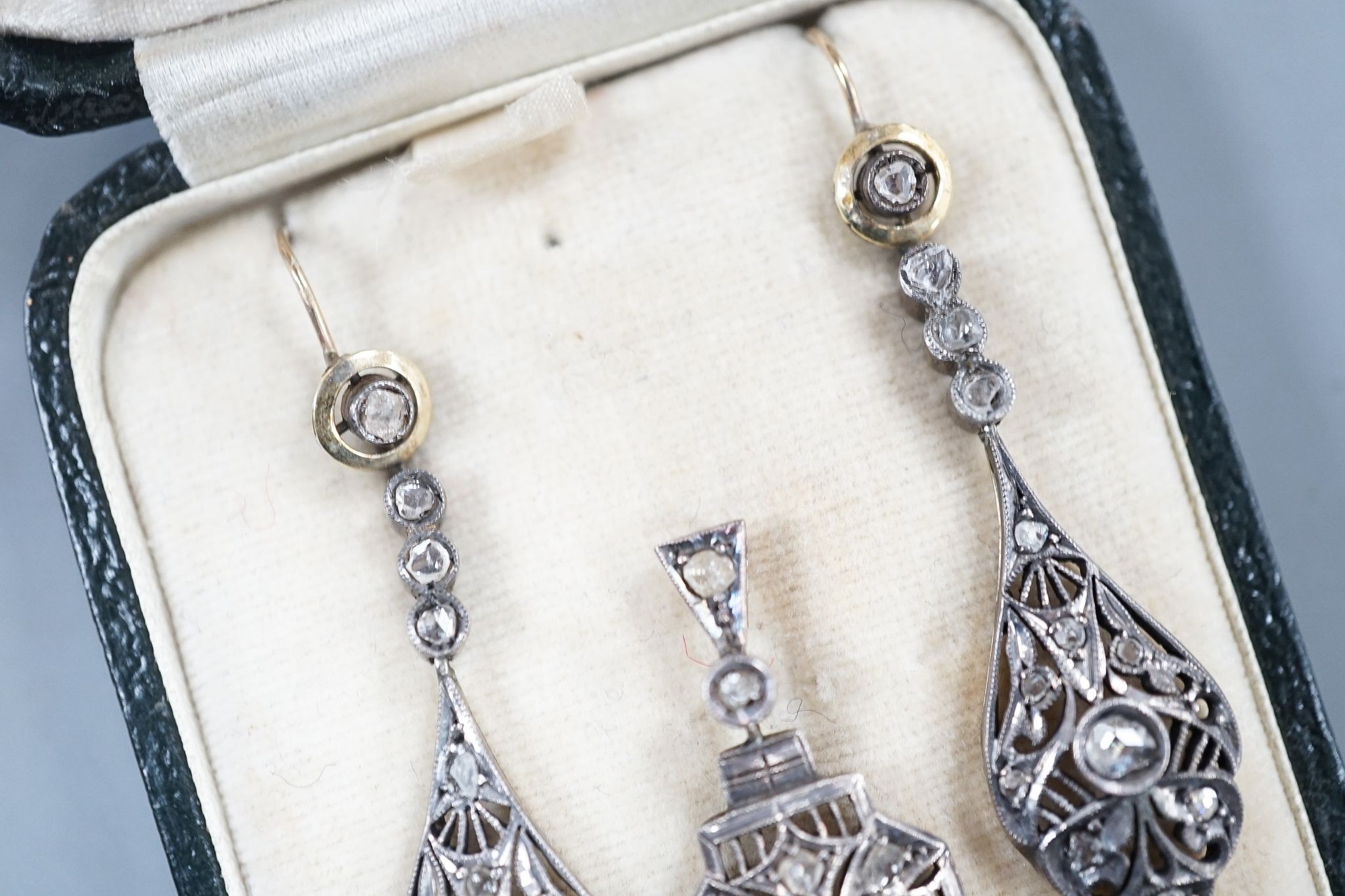 A 19th century pierced white and yellow metal and rose cut diamond set suite of jewellery, comprising a pendant 48mm and a pair of matching drop earrings, gross weight 11.2 grams.